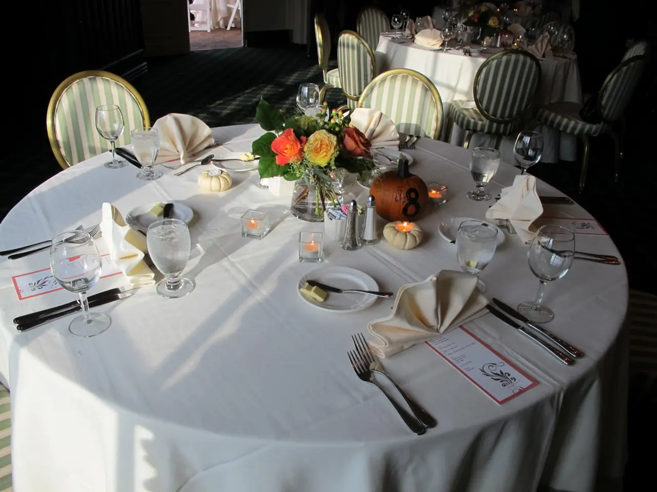 Creating homemade holiday table decorations, adorned with natural greenery and vibrant flowers