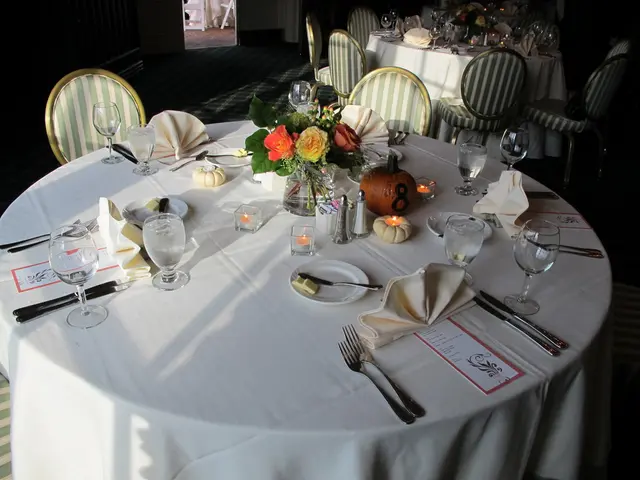 Creating homemade holiday table decorations, adorned with natural greenery and vibrant flowers