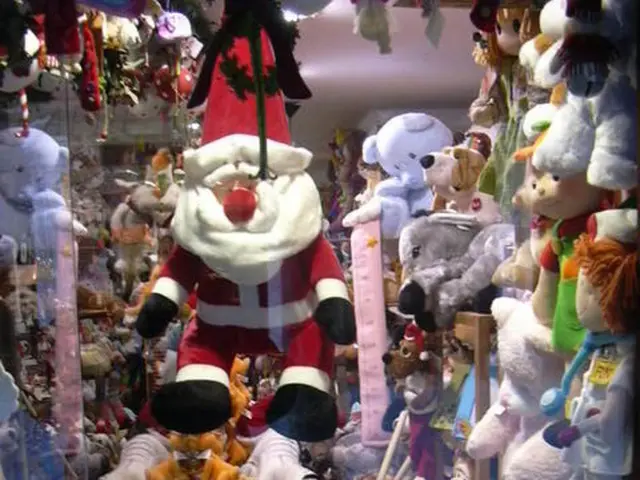 In the middle it's a doll of Christmas grand father and on the right side there are many teddy...