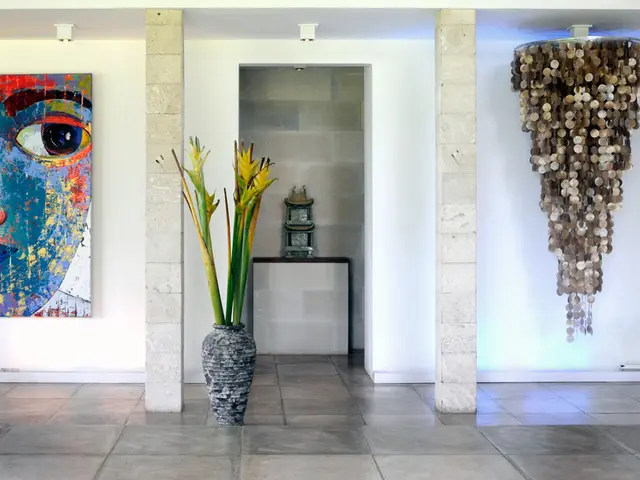 This picture describes about inside view of a room, in this we can find a flower vase, chandelier...