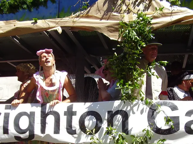 In the center of the image there are people standing under a tent. There are holding banner. There...